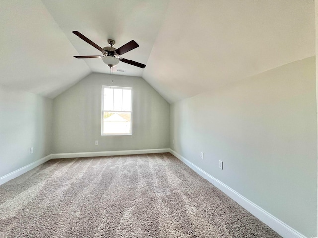 additional living space with vaulted ceiling, carpet flooring, and ceiling fan