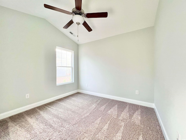 empty room featuring vaulted ceiling, carpet flooring, and ceiling fan