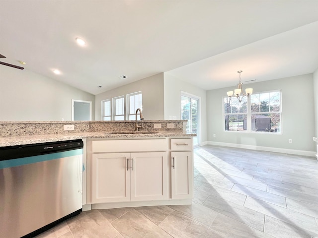 kitchen with white cabinetry, a healthy amount of sunlight, stainless steel dishwasher, and vaulted ceiling