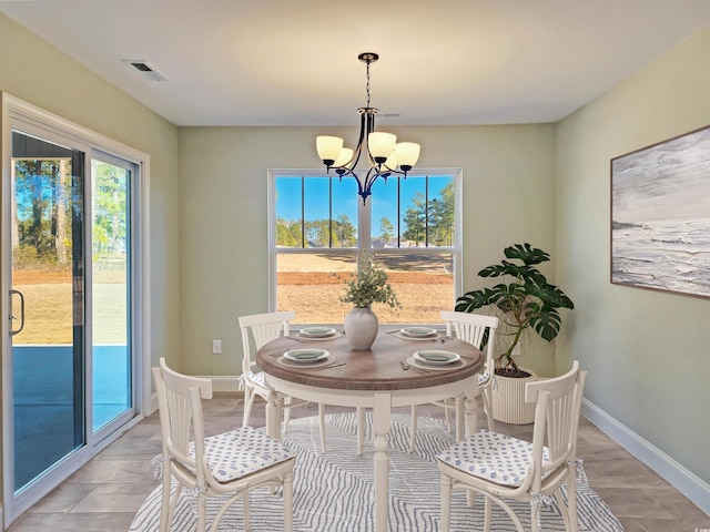 dining area featuring a notable chandelier