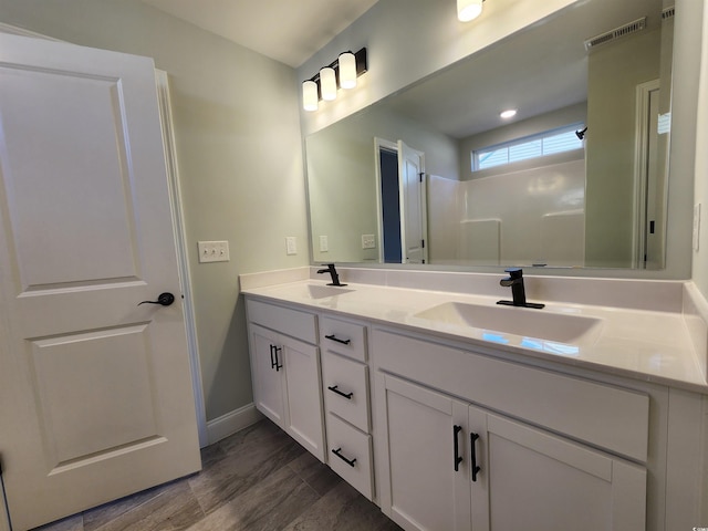 bathroom with vanity and wood-type flooring