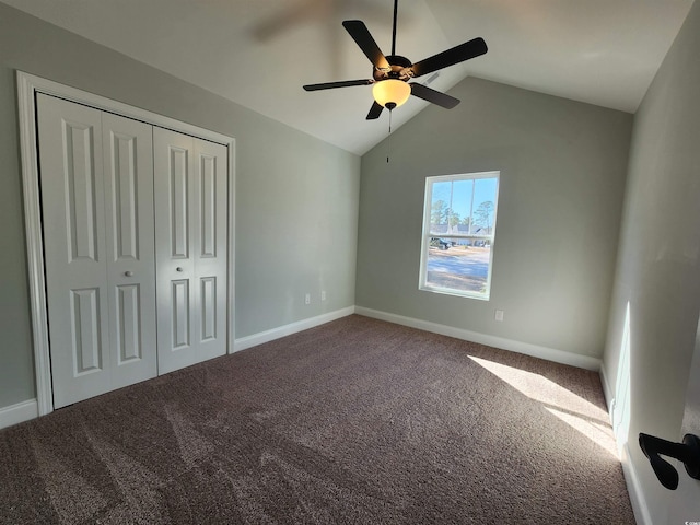 unfurnished bedroom featuring a closet, ceiling fan, carpet flooring, and vaulted ceiling