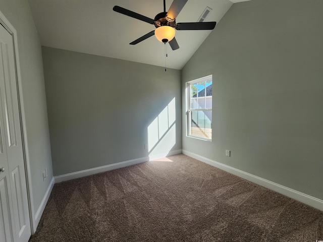 empty room featuring ceiling fan, high vaulted ceiling, and carpet flooring