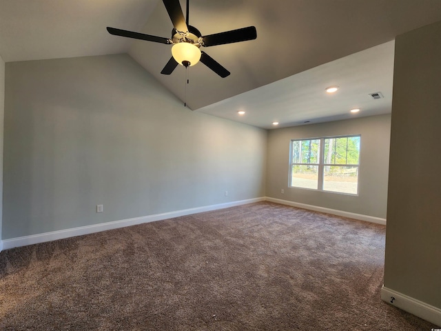 spare room featuring lofted ceiling, carpet floors, and ceiling fan