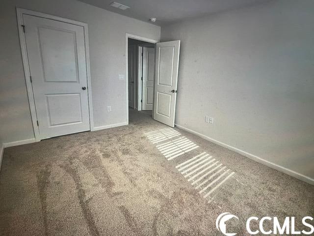 unfurnished bedroom with carpet flooring