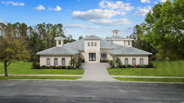 mediterranean / spanish-style home with a front yard