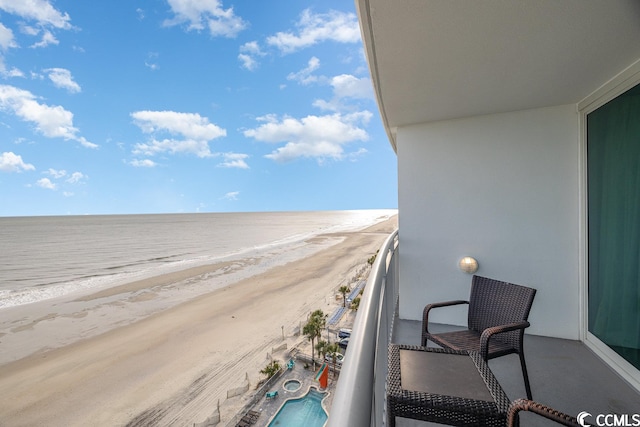 balcony with a beach view and a water view