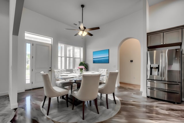 dining area featuring high vaulted ceiling, ceiling fan, and light hardwood / wood-style floors