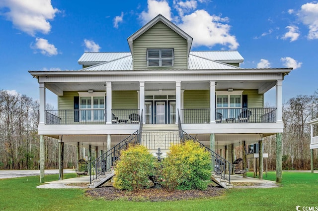 view of front facade with a front lawn, a balcony, and a porch