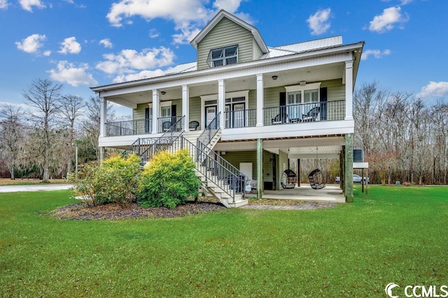 coastal home with covered porch and a front yard