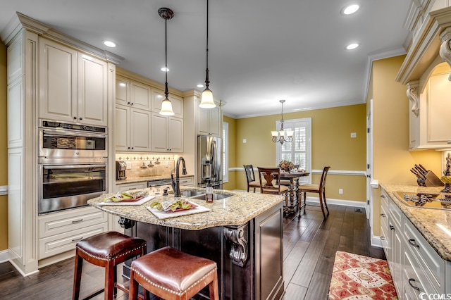 kitchen featuring a kitchen breakfast bar, appliances with stainless steel finishes, a chandelier, tasteful backsplash, and decorative light fixtures