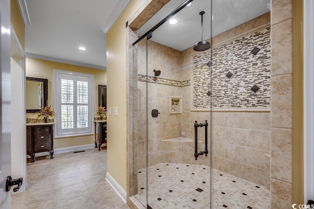 bathroom with tile floors, ornamental molding, vanity, and a shower with door