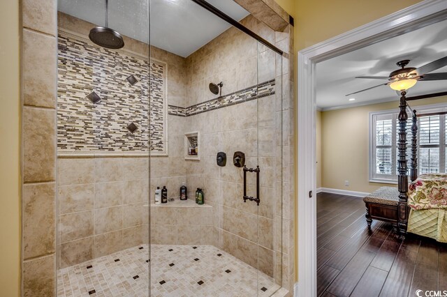 bathroom with ornamental molding, wood-type flooring, ceiling fan, and tiled shower