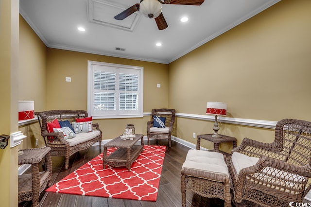 living area with crown molding, dark hardwood / wood-style floors, and ceiling fan