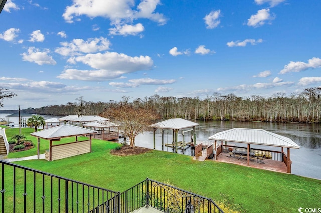 dock area featuring a water view and a lawn