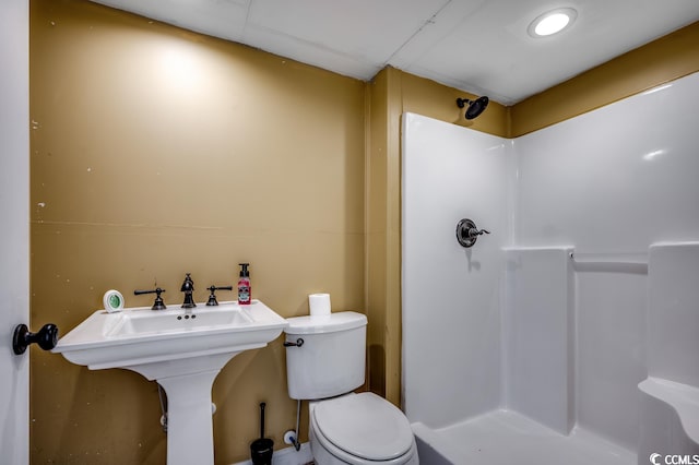 bathroom with walk in shower and toilet