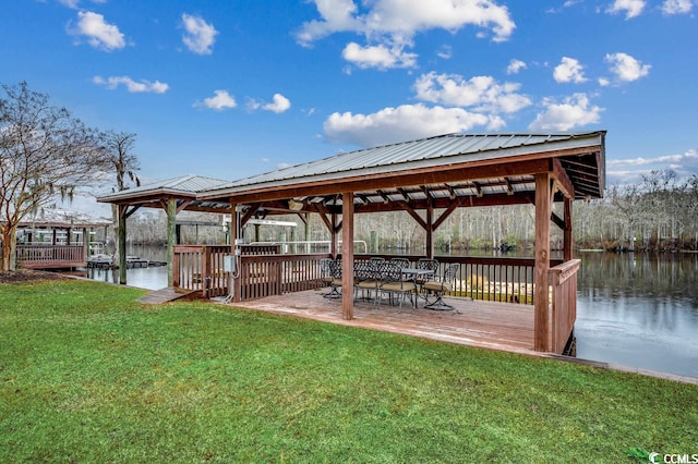 dock area featuring a water view and a lawn