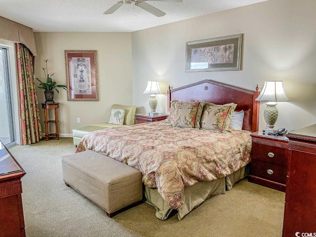 carpeted bedroom featuring a textured ceiling and ceiling fan