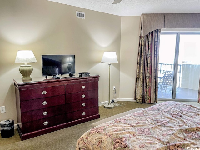 carpeted bedroom featuring access to exterior, ceiling fan, and a textured ceiling