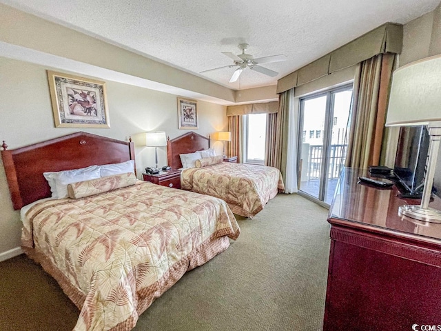 carpeted bedroom featuring ceiling fan, access to exterior, and a textured ceiling