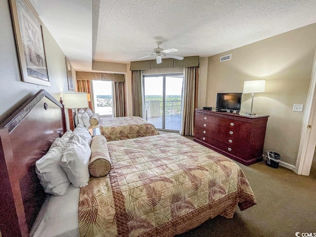 bedroom featuring a textured ceiling, ceiling fan, carpet, and access to exterior