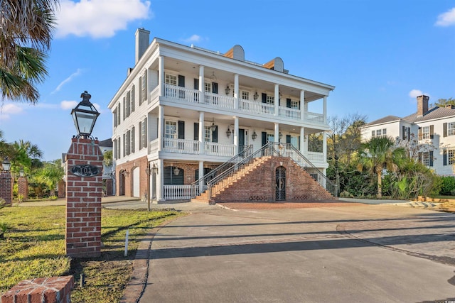 101 Greenwich Dr, Georgetown, SC 29440 - view of front of house with covered porch, stairway, and a balcony