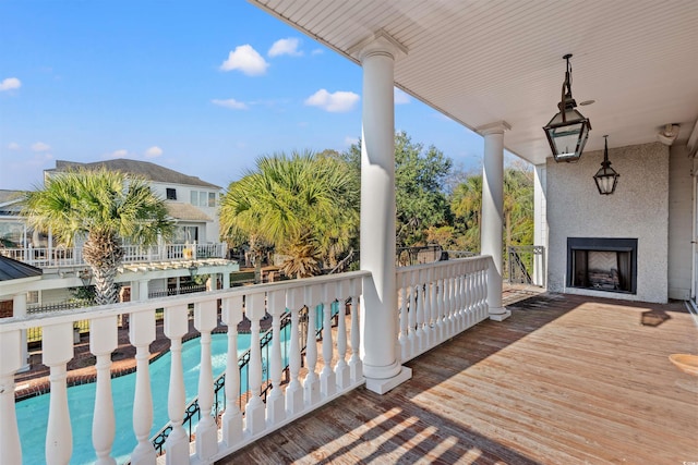 101 Greenwich Dr, Georgetown, SC 29440 - wooden terrace featuring an outdoor fireplace and an outdoor pool