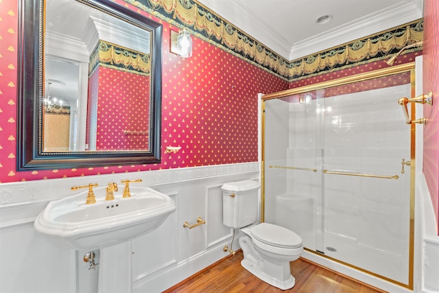 101 Greenwich Dr, Georgetown, SC 29440 - bathroom with wallpapered walls, ornamental molding, a wainscoted wall, wood finished floors, and a stall shower