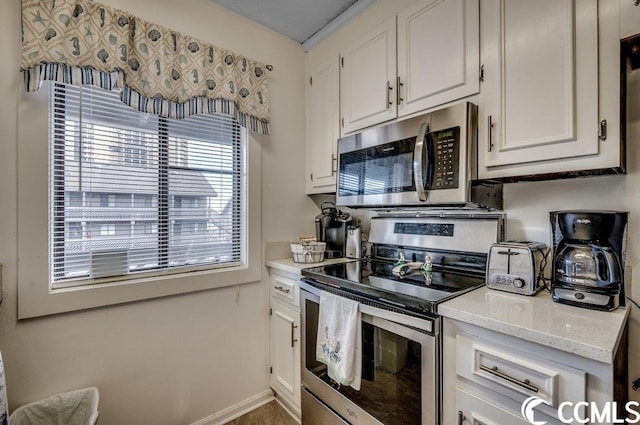 kitchen featuring appliances with stainless steel finishes and white cabinetry