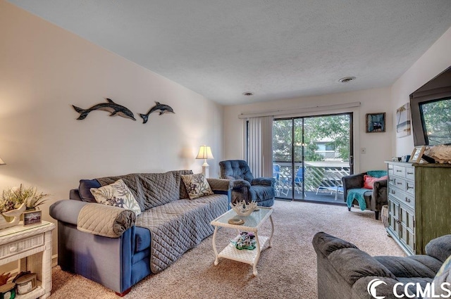 living room featuring a textured ceiling, a healthy amount of sunlight, and light carpet