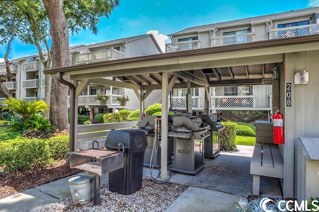 view of terrace with a balcony and grilling area