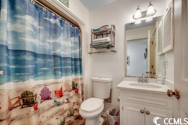 bathroom featuring large vanity and toilet