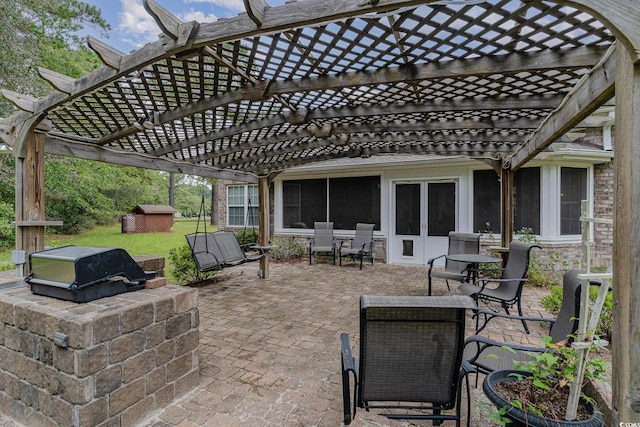 view of patio with a pergola, an outdoor kitchen, area for grilling, and a shed