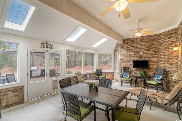 sunroom / solarium with ceiling fan and lofted ceiling with skylight