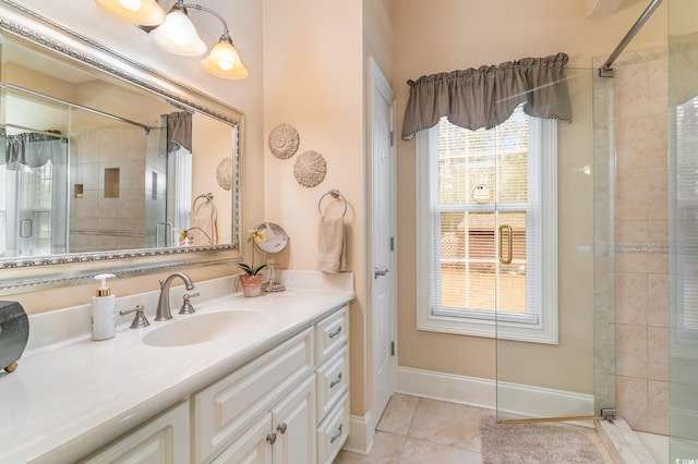 bathroom with tile patterned flooring, vanity, and a shower with door