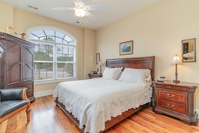 bedroom with light hardwood / wood-style floors and ceiling fan