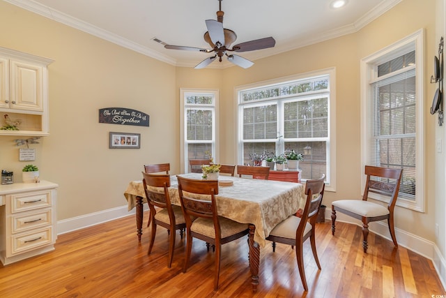 dining room with ceiling fan, light wood-type flooring, and crown molding