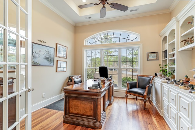 home office with ceiling fan, ornamental molding, and light wood-type flooring