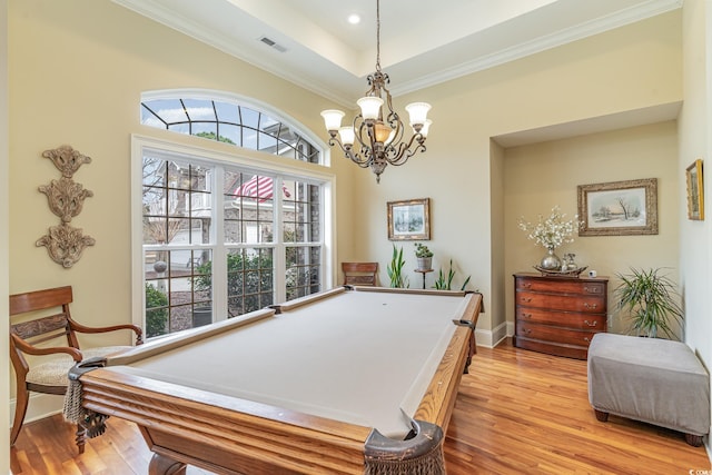 game room featuring light wood-type flooring, a wealth of natural light, ornamental molding, and billiards