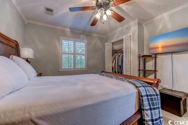 bedroom featuring a closet, a textured ceiling, ceiling fan, and ornamental molding