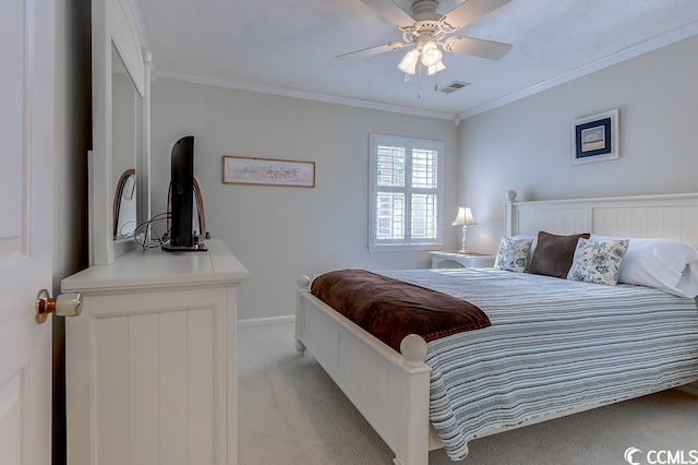 carpeted bedroom featuring ceiling fan, ornamental molding, and a textured ceiling