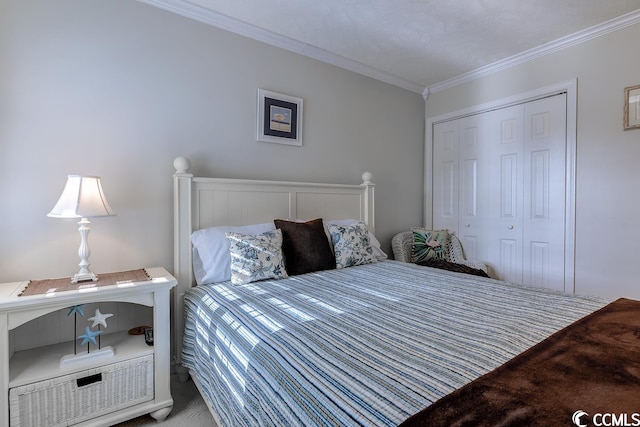 carpeted bedroom featuring ornamental molding and a closet