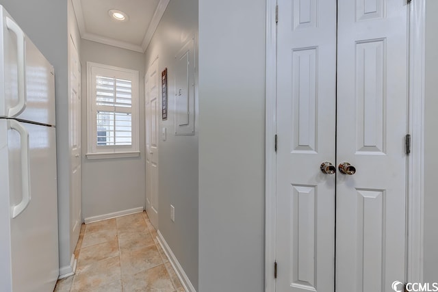 hall with ornamental molding and light tile flooring