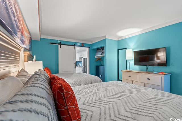 bedroom featuring a barn door, stainless steel refrigerator, and ornamental molding