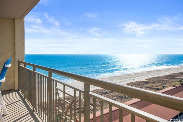 balcony featuring a water view and a beach view