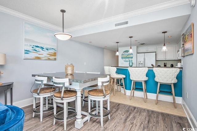 603 S Ocean Blvd Unit 1115, North Myrtle Beach, SC 29582 - dining room with crown molding, wood finished floors, and baseboards