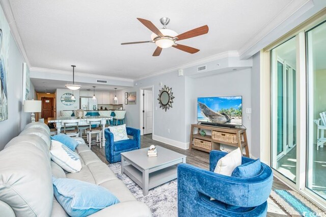 603 S Ocean Blvd Unit 1115, North Myrtle Beach, SC 29582 - living room featuring wood finished floors, crown molding, a ceiling fan, and baseboards