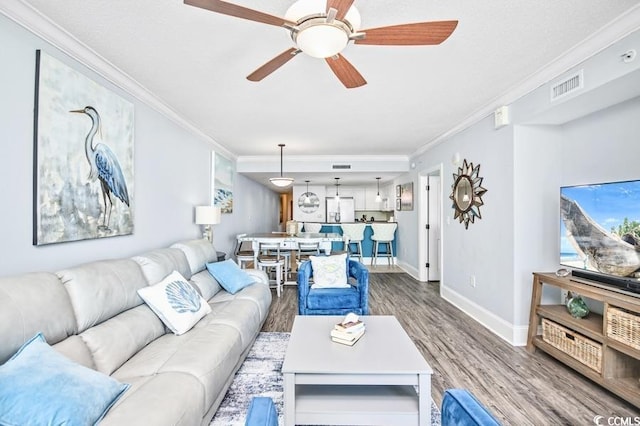 603 S Ocean Blvd Unit 1115, North Myrtle Beach, SC 29582 - living area featuring wood finished floors, ornamental molding, baseboards, and a ceiling fan