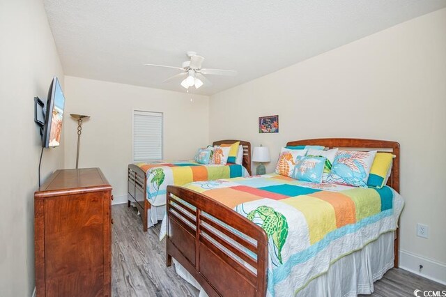 603 S Ocean Blvd Unit 1115, North Myrtle Beach, SC 29582 - bedroom featuring wood finished floors, baseboards, and ceiling fan
