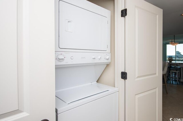 603 S Ocean Blvd Unit 1115, North Myrtle Beach, SC 29582 - clothes washing area featuring stacked washer / drying machine and tile patterned floors